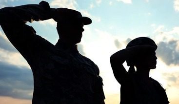 Two soldiers in salute pose