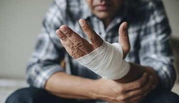 Individual holding arm with bandaged wrist