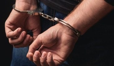 Close-up of hands in handcuffs